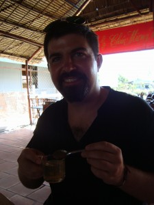 John samples tea with natural honey on a bee farm.